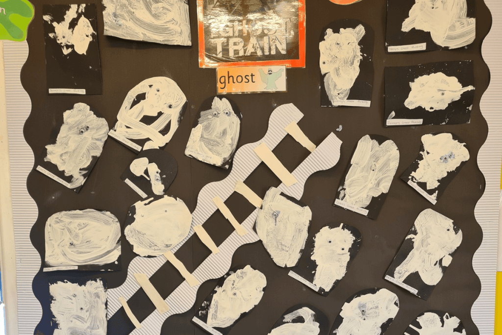 Ghost train paintings from kids on a wall
